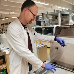 Martin Christman fills sample tubes into a bulk loader, which automatically...