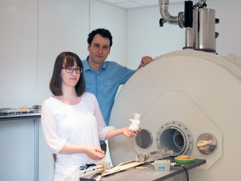 scientists standing next to a mri scanner for small animals