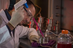 Rice University graduate student Marco Santoro fills a custom bioreactor with...