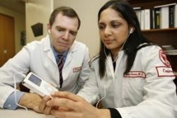 Study authors Mike Barrett and Archana Saxena listen to heart sounds on an...