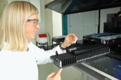 A lab assistant from Siemens in front of the pipetting robot Versant kPCR.