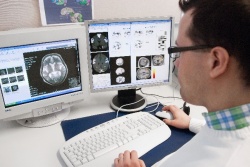 Dr Pekka Miettinen is analysing MRI scans. (Photo source: the University of...