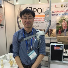 Hyung Seok Kim, CEO mobiU, demonstrates
the use of EZpole – a wearable IV...
