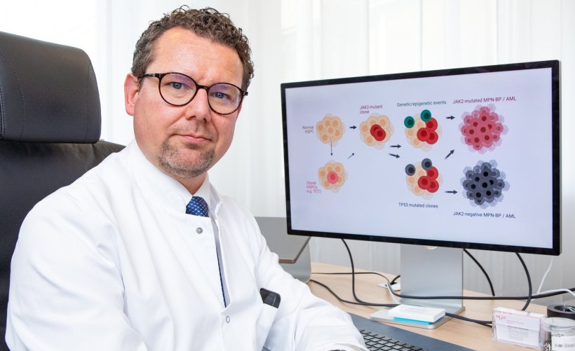 florian heidel sitting next to computer screen showing blood stem cell schematic
