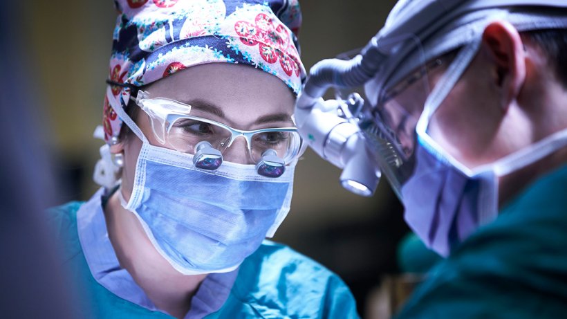 female surgeon wearing face mask in operating theatre
