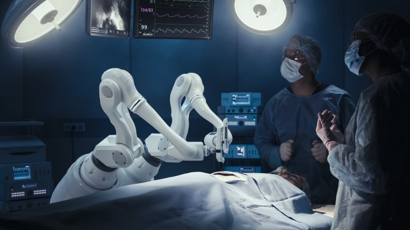 two surgeons observing robotic surgery intervention in operating room