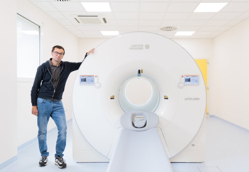 radiologist stefano fanti standing next to pet-ct scanner