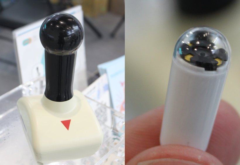 A Joystick-like device on the left and a small capsule on the right