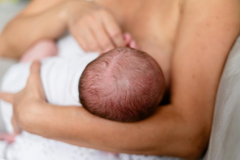 Closeup photo of mother breastfeeding her baby