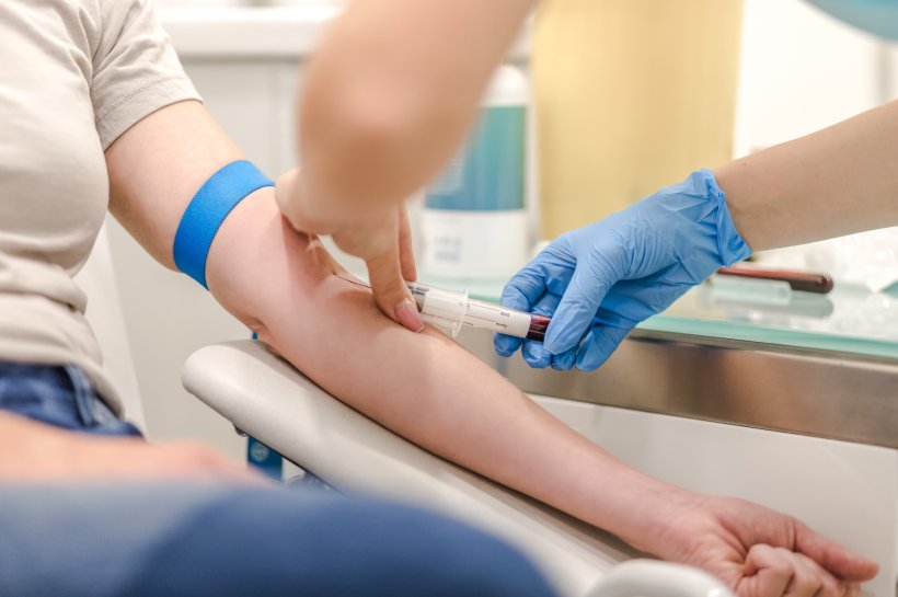 Close-up Of Doctor Taking Blood Sample From Patients Arm in Hospital for...