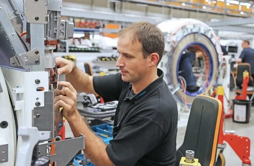 Ein Mitarbeiter von Siemens Healthineers bei der Fertigung eines CT-Scanners in...