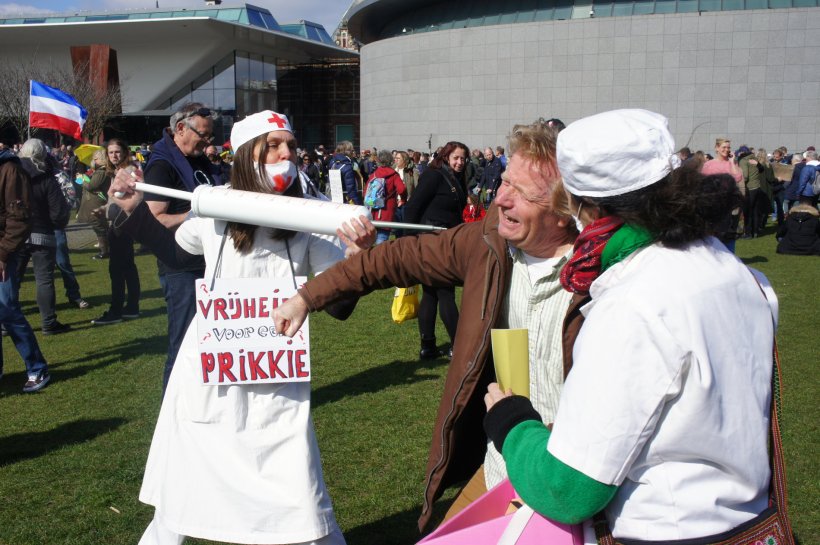 During an ati-vaccination demonstration, a women dressed as nurse threatens a...