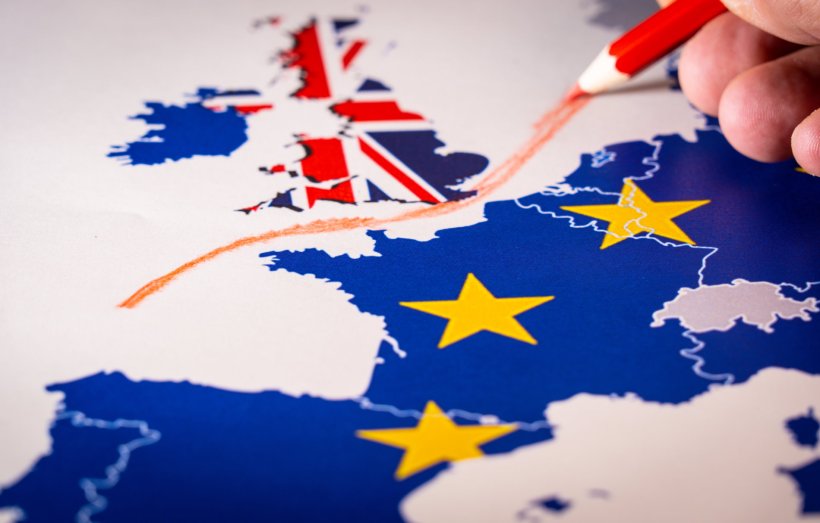 A map of Europe, with a hand drawing a red line between the UK and EU...