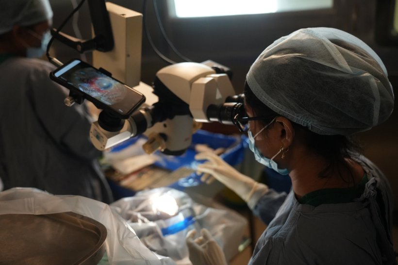 A female surgeon performing cataract surgery. The procedure is recorded on...
