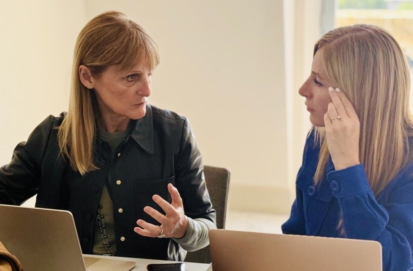 Marie-Pierre Revel is engaged in a discussion with another participant of a...