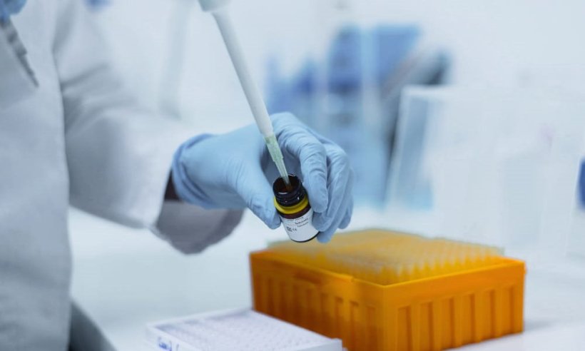 A round glass container is filled with a pipette in a laboratory setting
