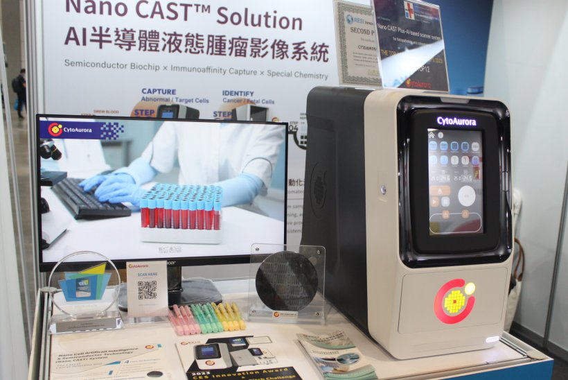A laboratory sample analyzer on display at a medical technology expo
