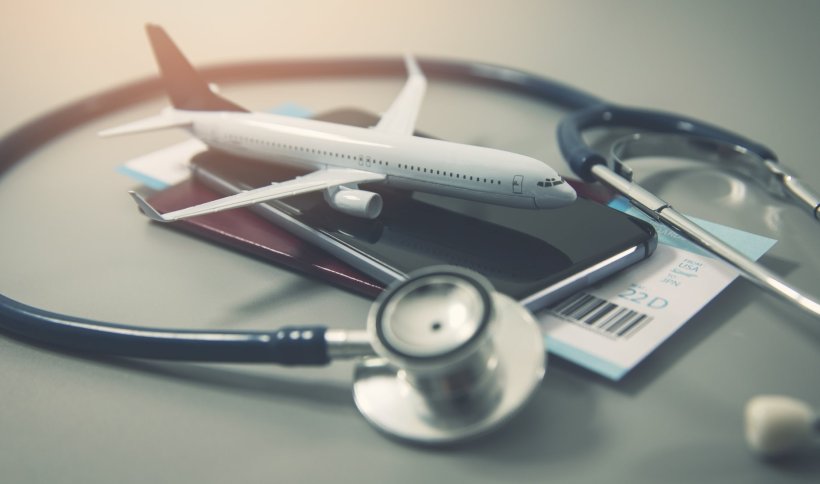 Model of an airplane on top of a travel passport with boarding pass, encircled...