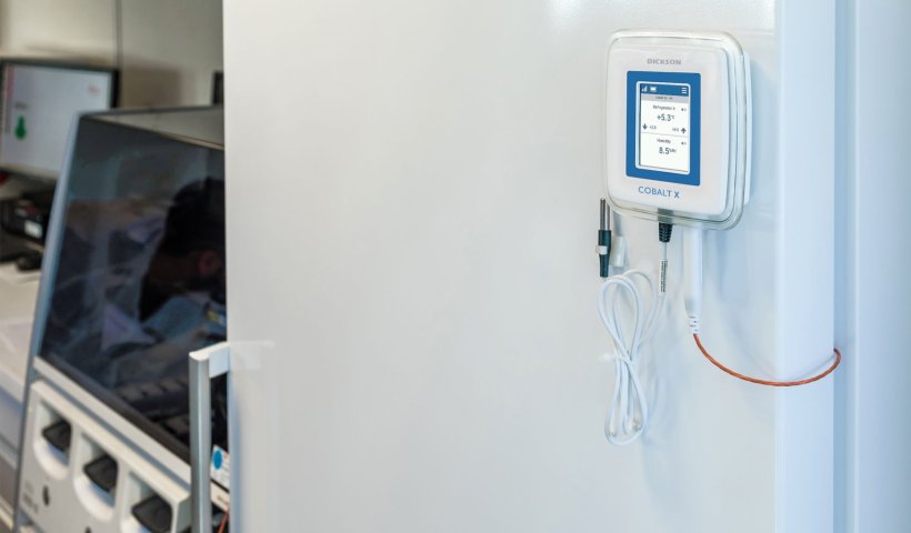 An environmental sensor placed on a fridge in a laboratory environment