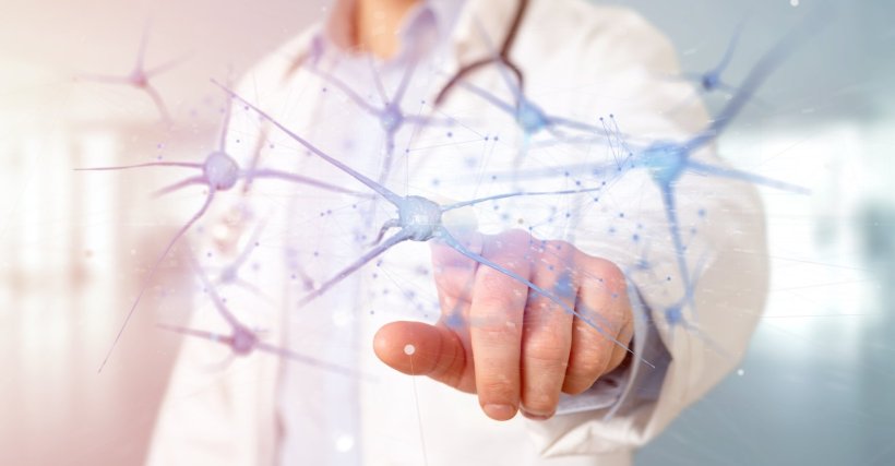 From the background, a doctor in a white coat is pointing at a network of...