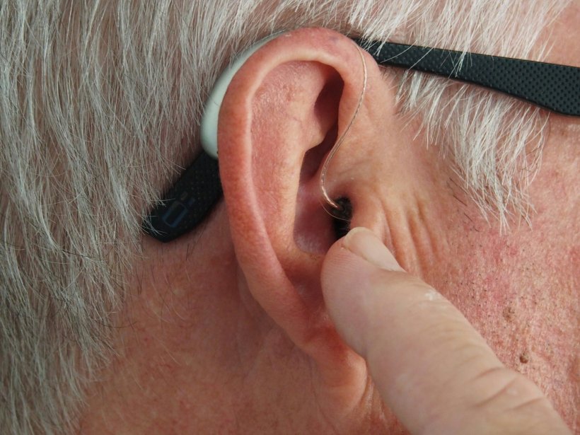 Closeup photo of a persons ear with hearing aid