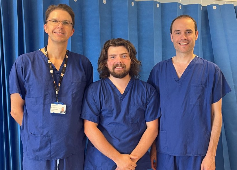 Stuart Robertson, Alex Newman and Gavin Morley in scrubs standing next to each...