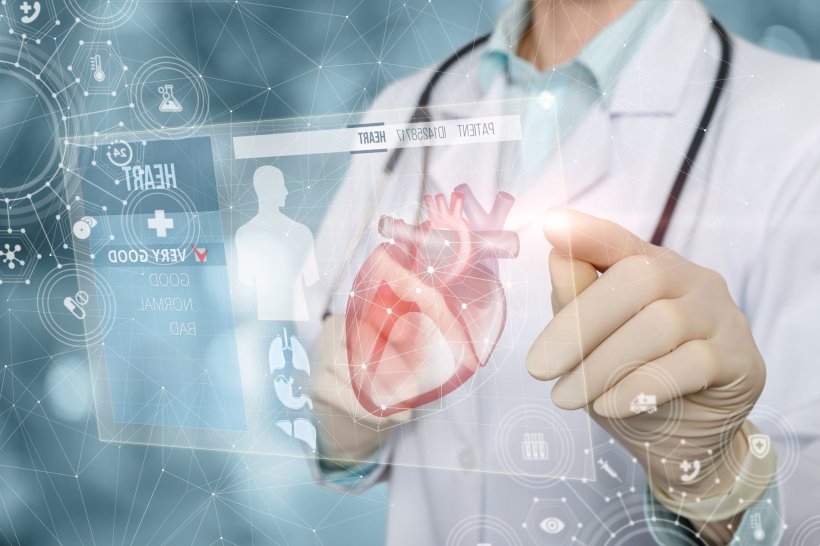A doctor in a white coat and wearing a stethoscope is using a virtual digital...