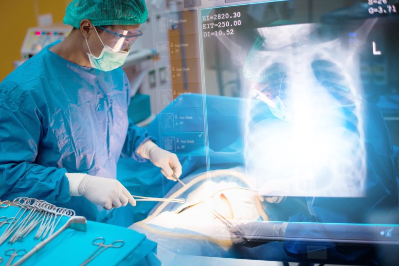 A surgeon is performing surgery on his patient in a hospitals operating room....