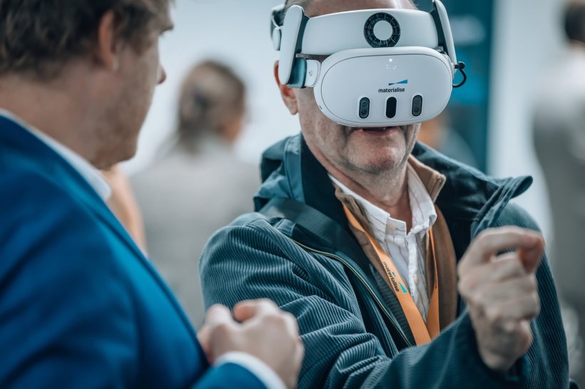 A man wearing a VR headset making a pinching gesture with his right hand