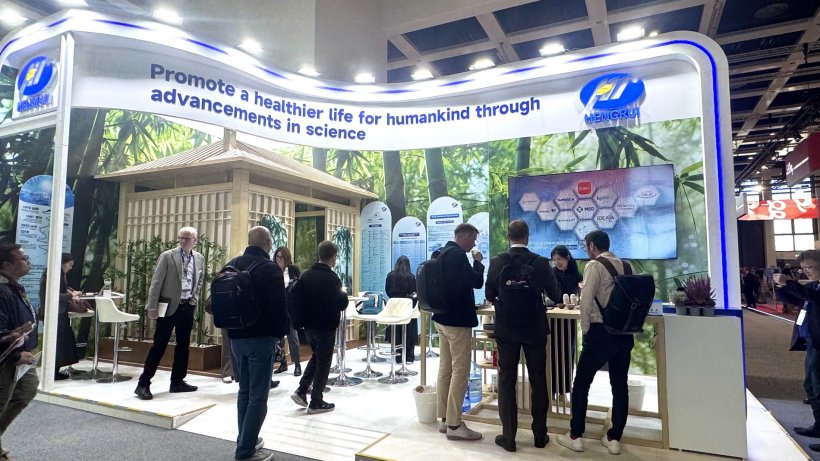 At the ESMO oncology congress, visitors gather at the booth of Chinese company...