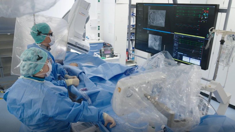 Medical professionals performing a procedure using interventional imaging