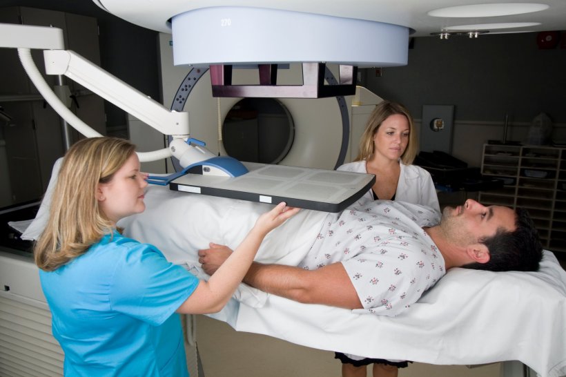 A man is undergoing radiotherapy for prostate cancer. The radiotherapy device...