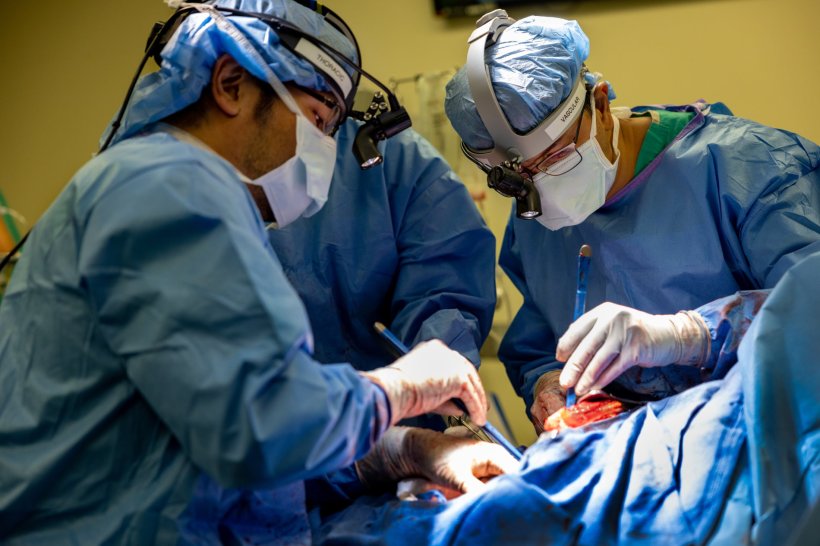 Two surgeons performing lung surgery on a patient in a hospital