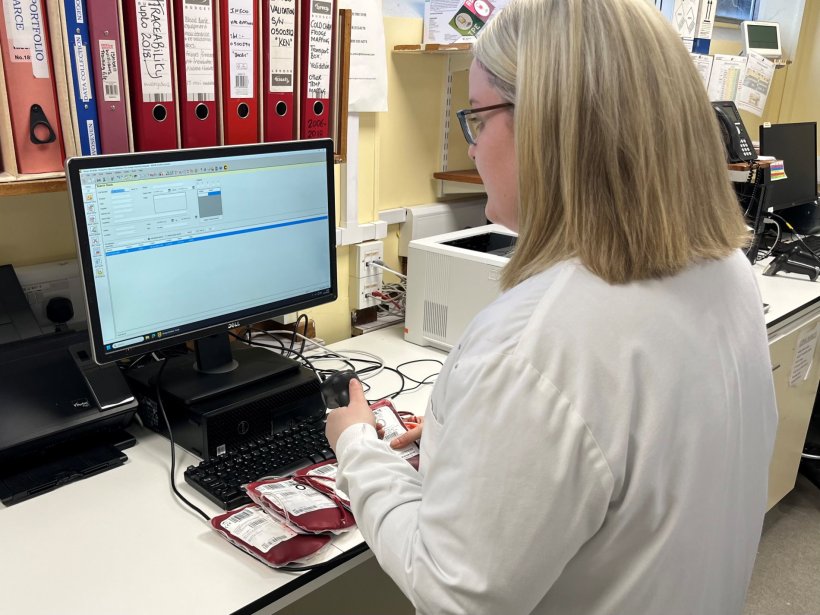 A laboratory medicine expert working in a lab. She is standing in front of a...