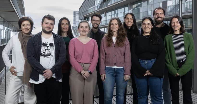 Ten people are standing next to each other for a team photo