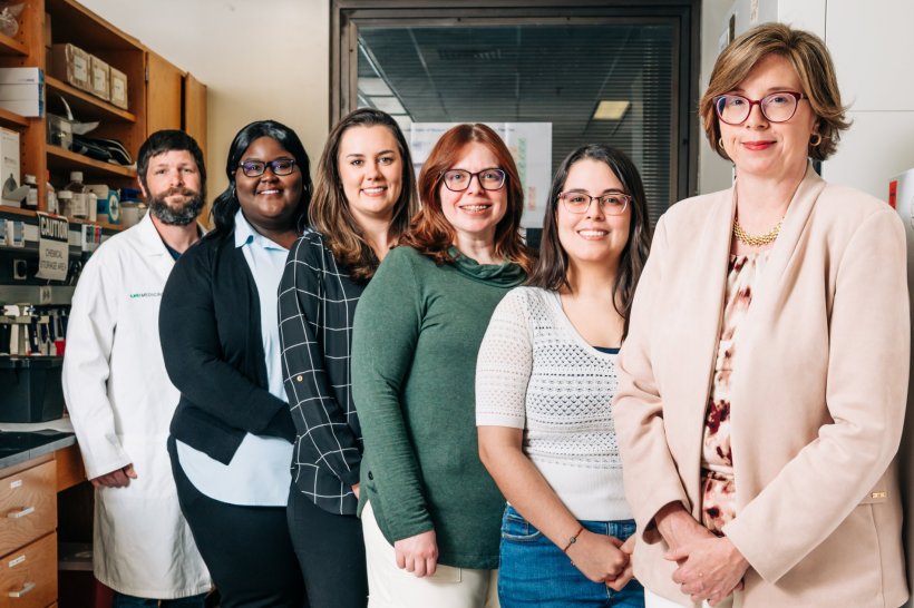Six researchers standing in a laboratory for a team photo