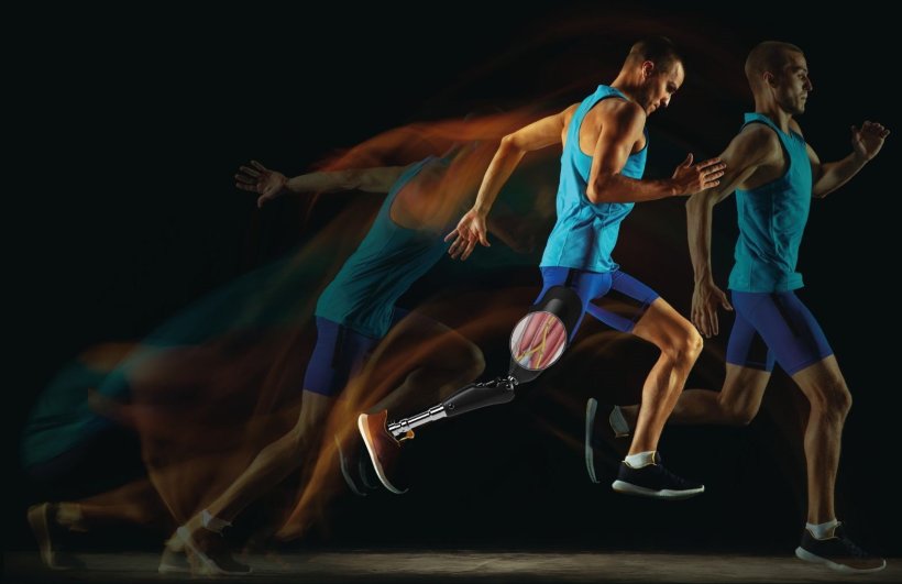 Multi-exposure photo of a man with a prosthetic leg performing a long jump from...