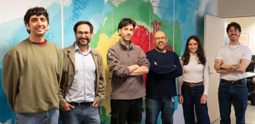 Six people standing next to each other for a team photo