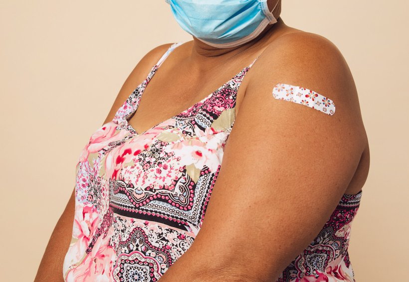 Cropped photo of an overweight woman wearing a protective face mask and having...