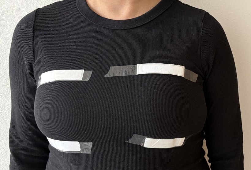 Cropped photo showing the upper body of a woman wearing white strips of plaster...