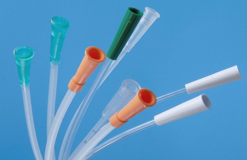 Nine reusable urinary catheters bundled against a blue background