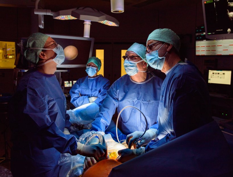 A surgical team of four performing fetal surgery in a hospitals operating room