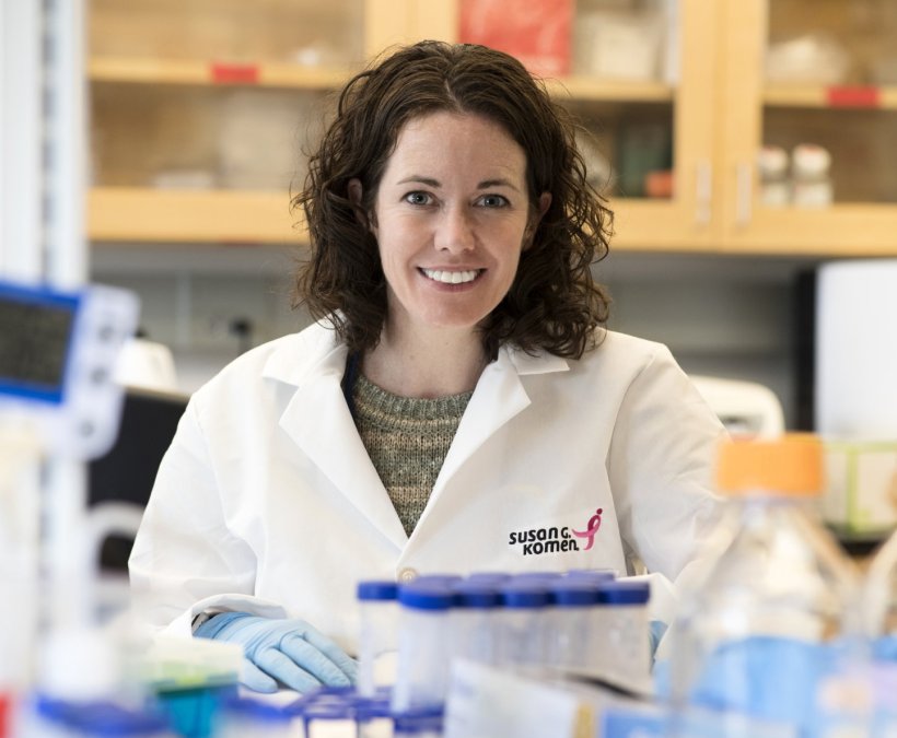 Melanie Rutkowski, PhD, is sitting in a laboratory environment, surounded by...