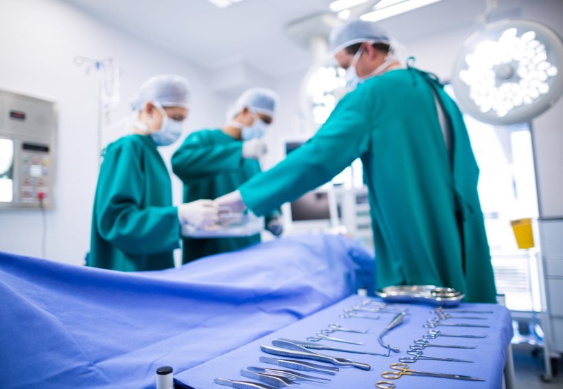 Surgeons performing operation in operation theater of a hospital. In the...