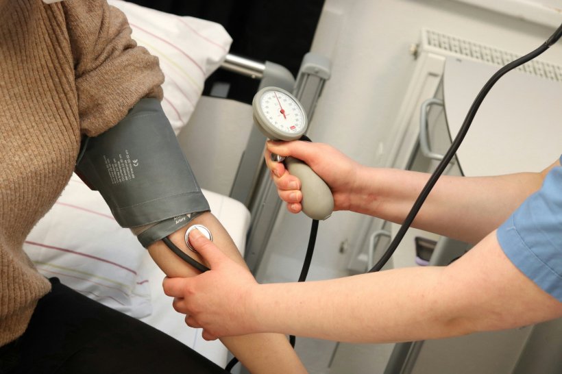 A nurse is performing a blood pressure measurement on her patient
