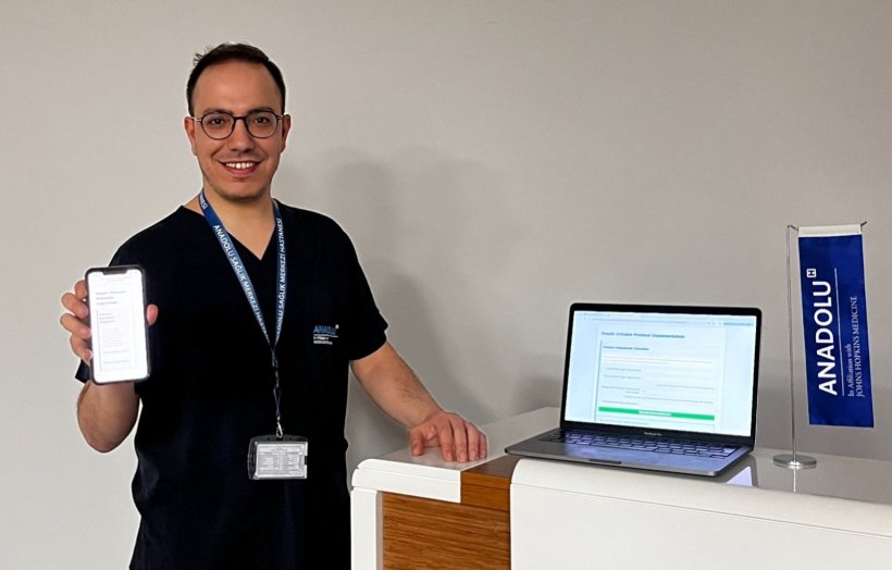 Gurkan Camok with the Digital Insulin Infusion Assistant displayed on mobile...