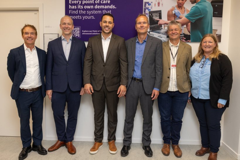 Six persons standing in a row for a group photo