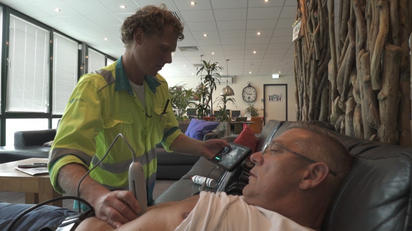 Geert-Jan Deddens scanning a patient via point-of-care ultrasound