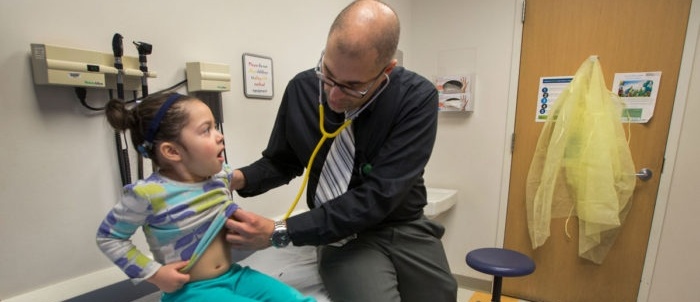 Amjad Horani, MD, listens to the breathing of Azaylea Ramirez, 3, of Keota,...