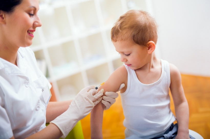 Stock photo of pediatrician making vaccination to small boy